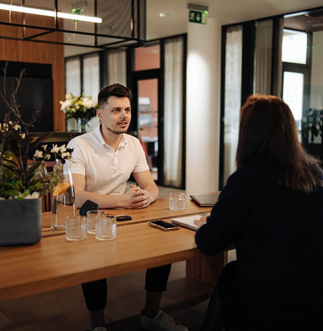 Colleagues in an informal conversation at an office table