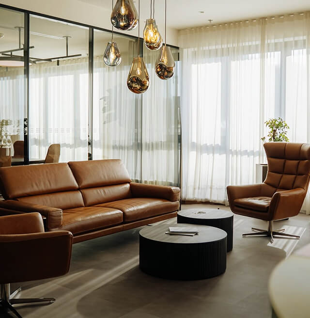 Office lounge area with brown leather sofas