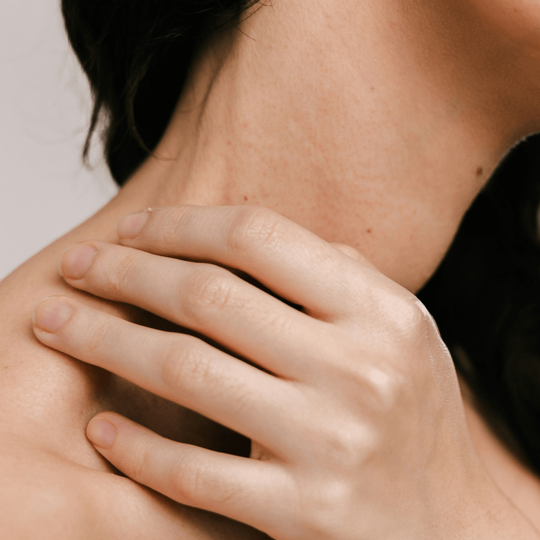 Close-up of a hand resting on a shoulder, representing personalized and specialized care