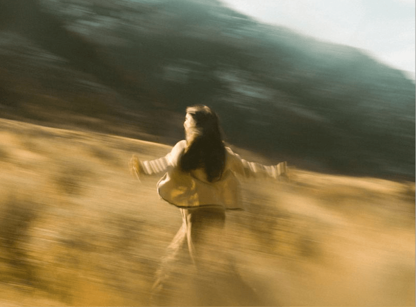 Woman walking through a mountainous landscape