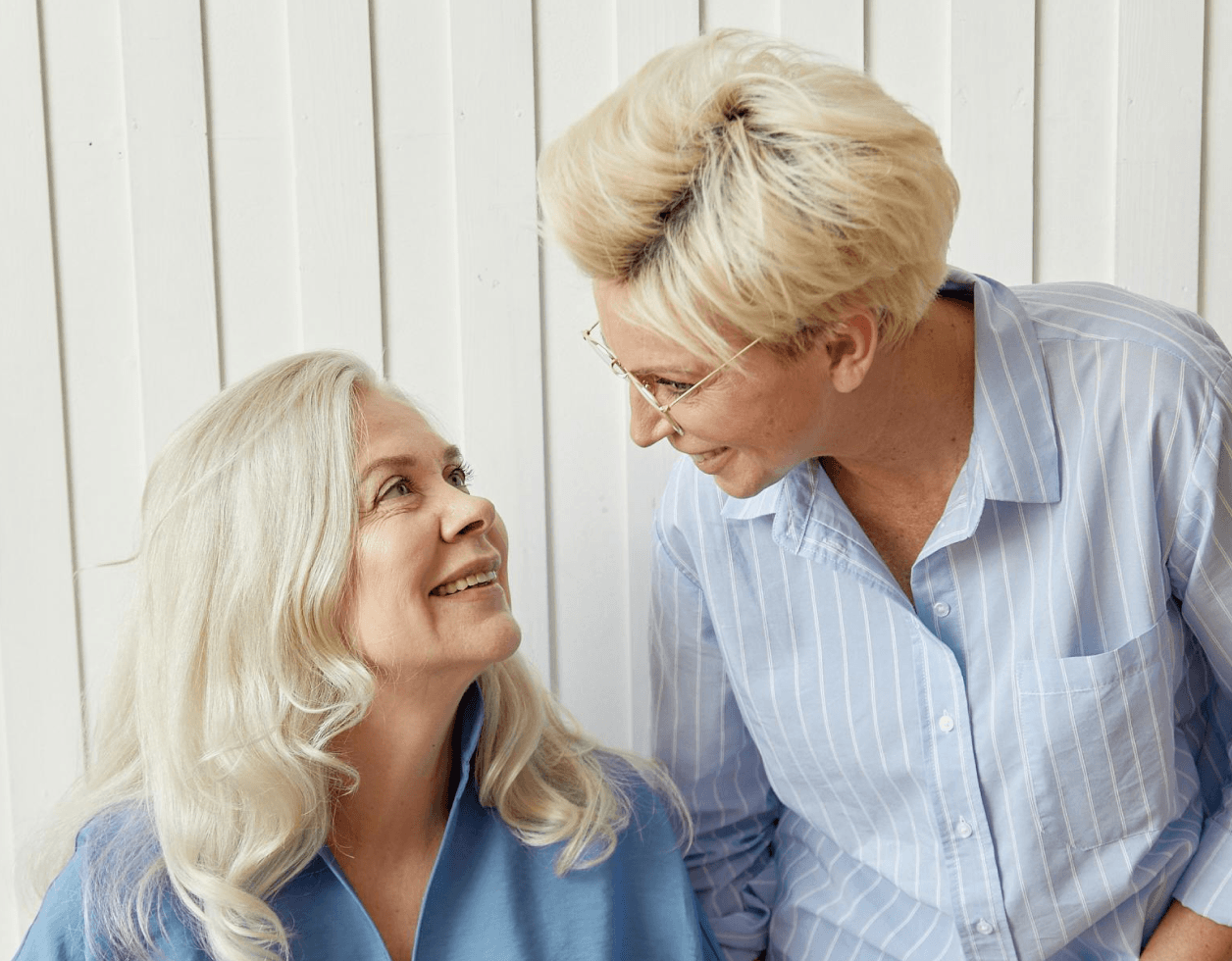 Two older adults smiling together