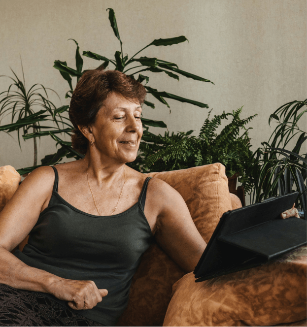Person using a tablet while seated indoors