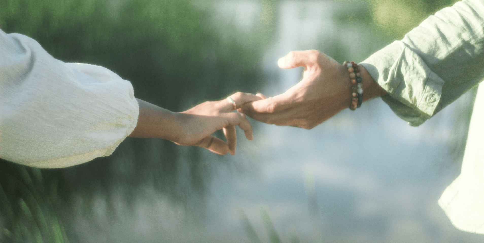 Two hands reaching toward one another