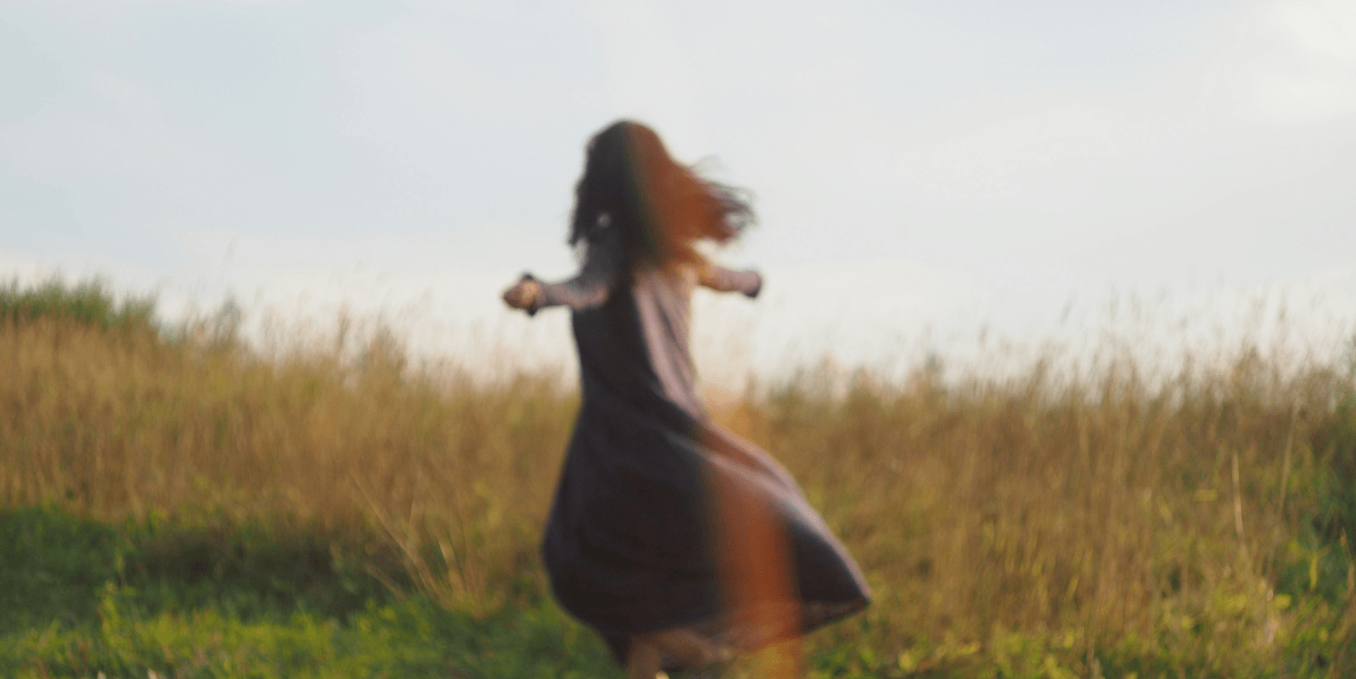 Person moving through a grassy field