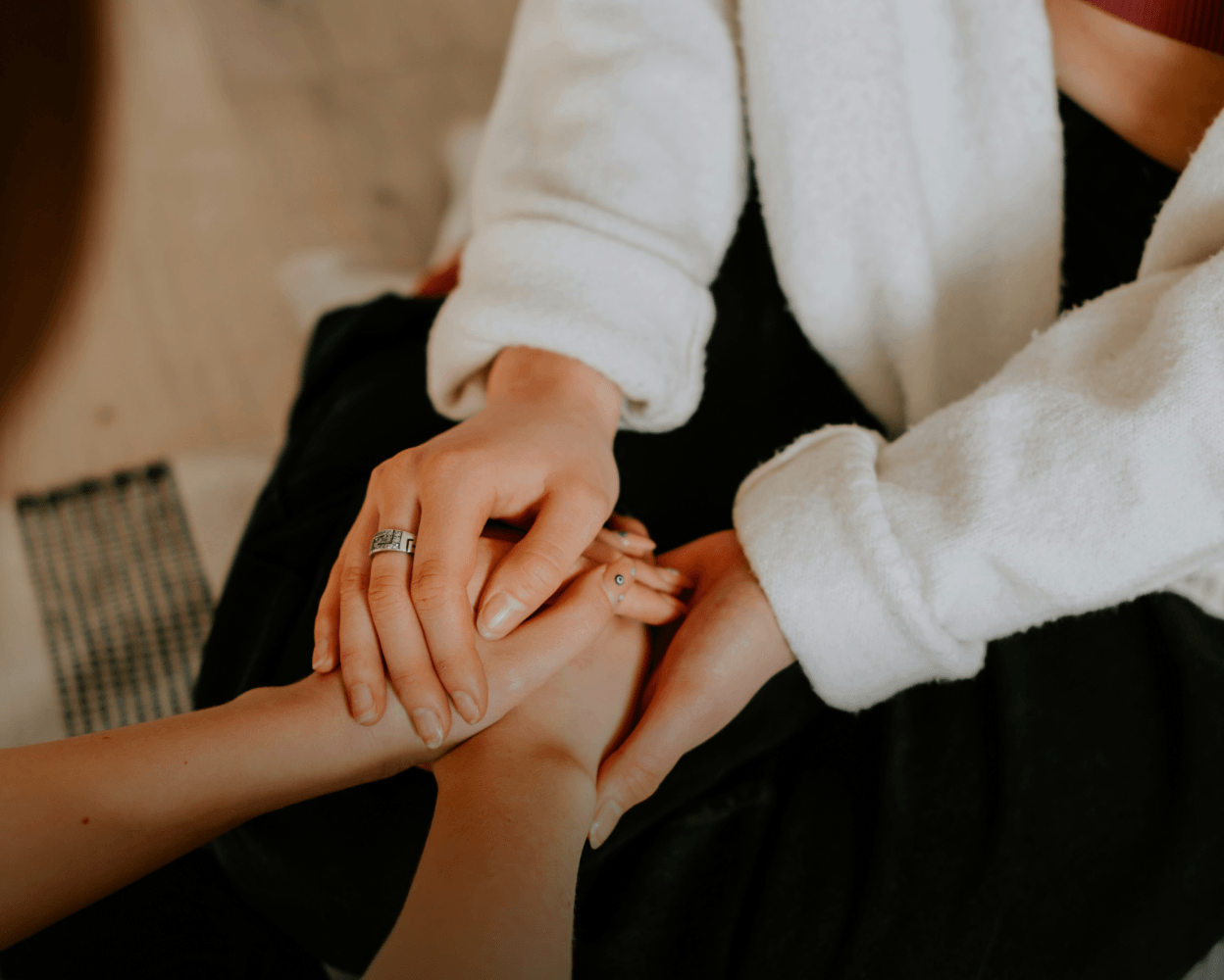 One person holding another person's hand