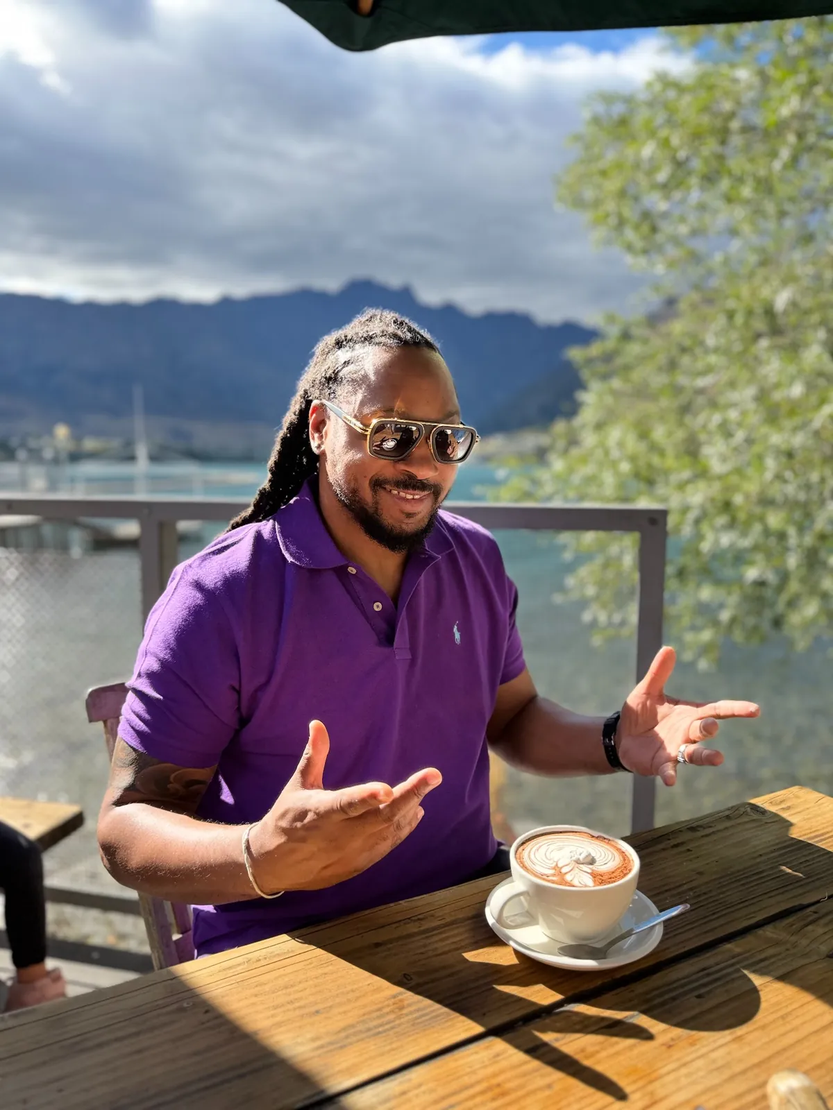 A Haitian Nomad traveler at a lakeside café in Queenstown, New Zealand