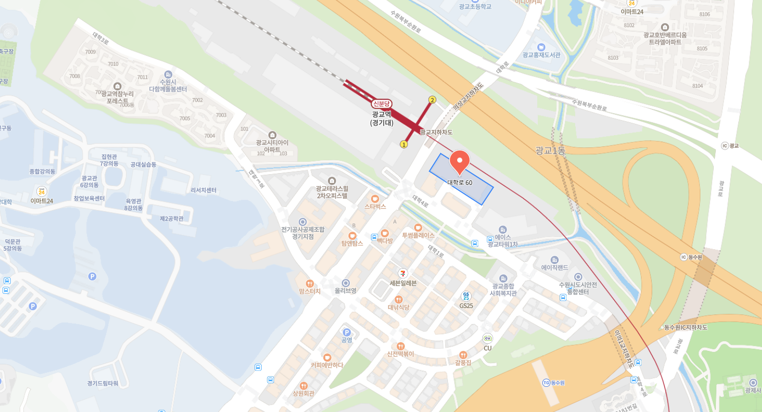 Map showing the location of Daehak-ro 60, near Gwanggyo Station in Suwon, South Korea. The map includes surrounding landmarks, roads, and facilities such as shops, offices, and residential areas.