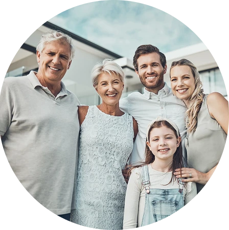 Multi-generational family smiling outdoors