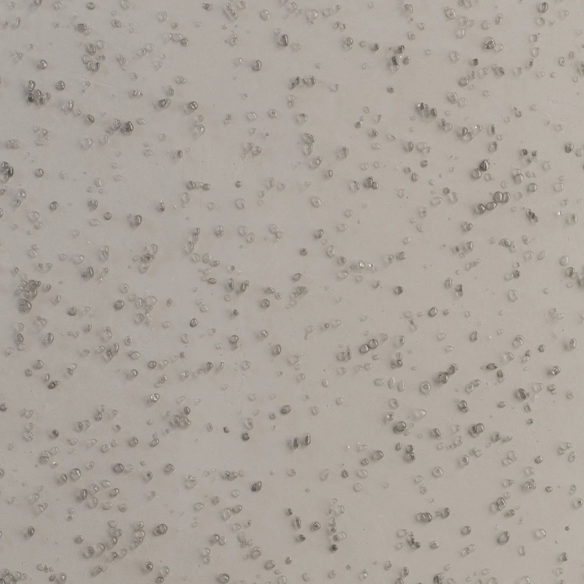 De muur is bedekt met een waterafstotende decoratieve coating. Er zijn waterdruppels zichtbaar op de muur; ze blijven eraan hangen, maar worden niet geabsorbeerd.