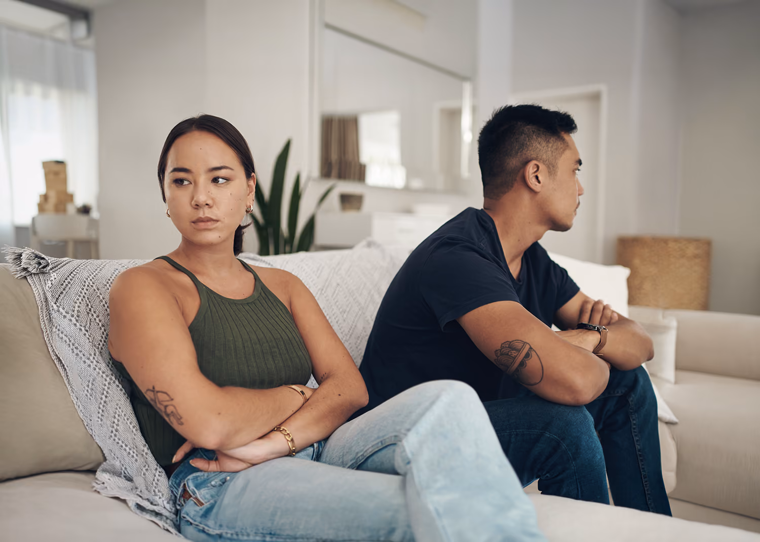 A couple in a calm therapy office, seated across from Dr. James Bass during a couples counseling session in Plano, TX