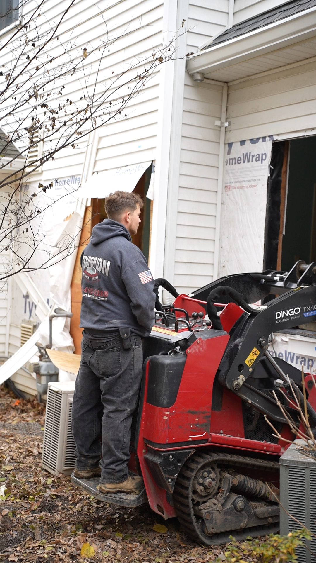 Crew running skid steer at a residential driveway