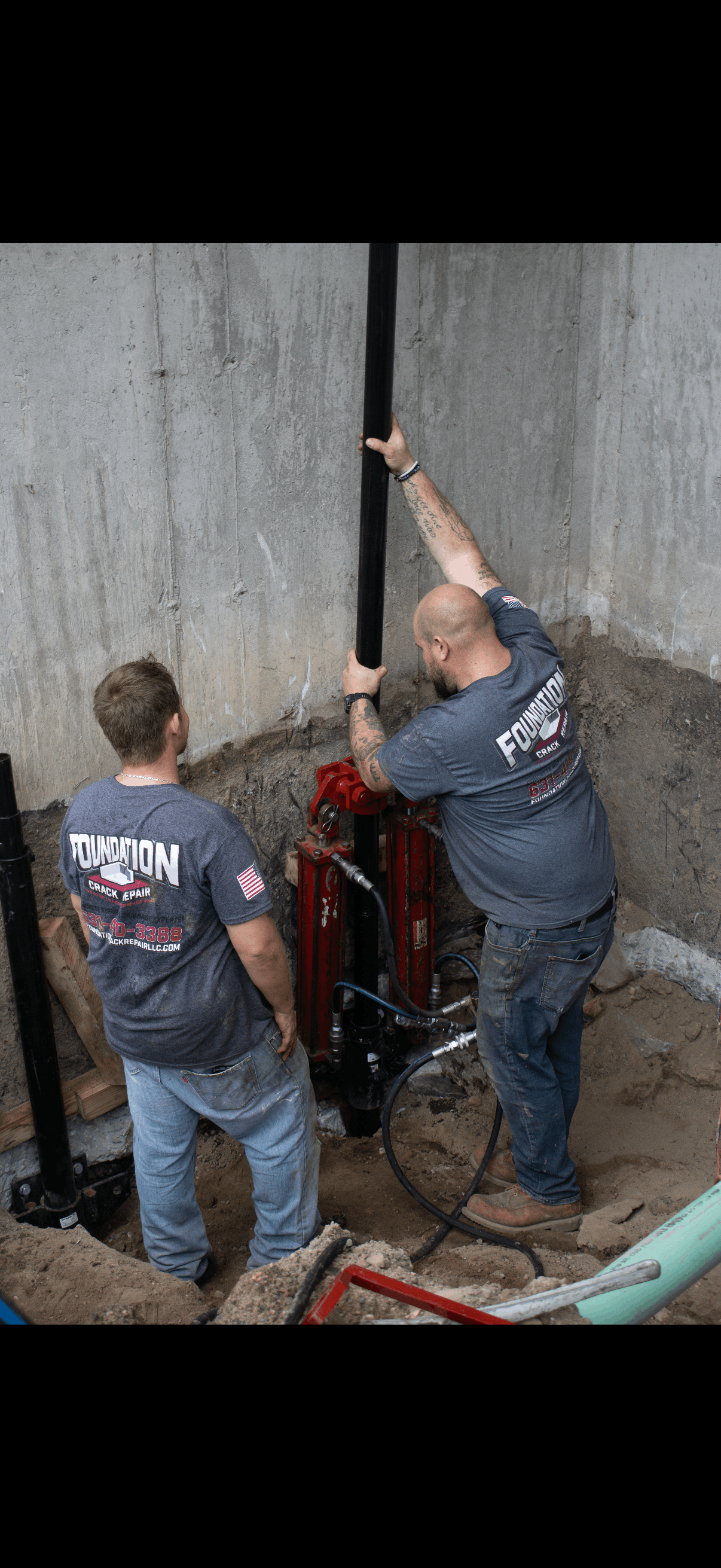 Helical pier installation crew stabilizing a Long Island foundation