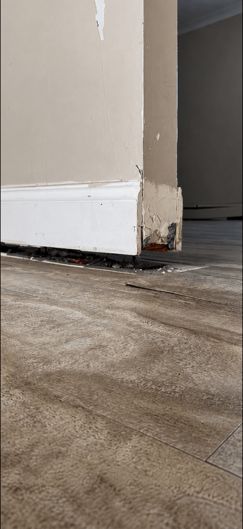 Tech installing a crawl space jack post under sagging joists