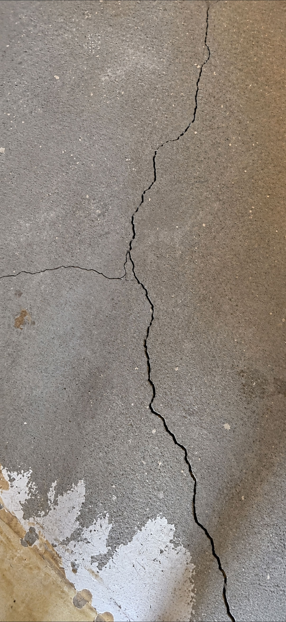 Tech inspecting a crawl space jack post