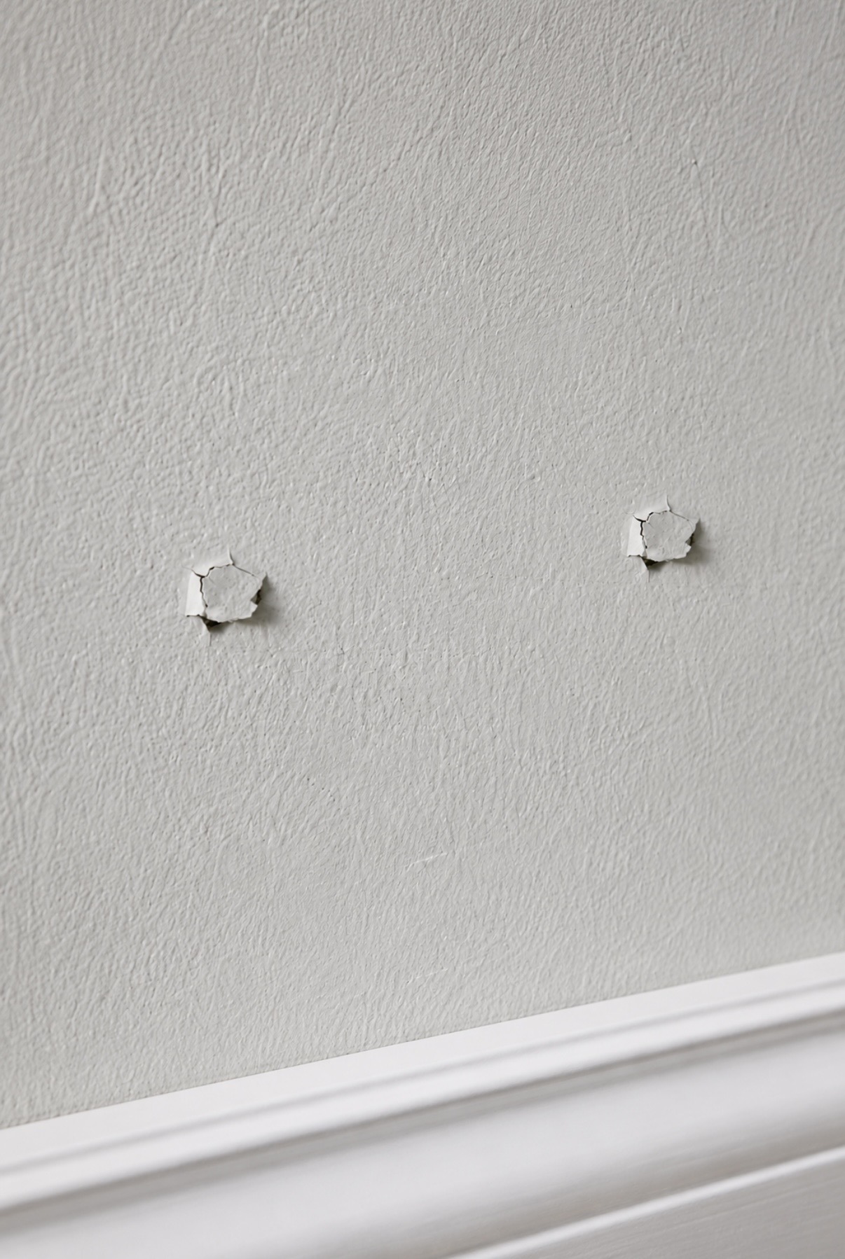 Foundation Crack Repair tech working on an interior wall