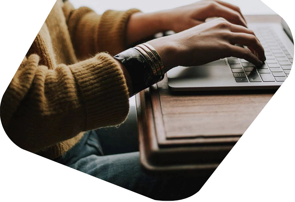 Hands typing on laptop