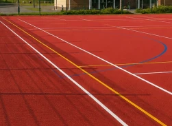 Red sports track with white, yellow, and blue lines for resn bound athletic events and activities.