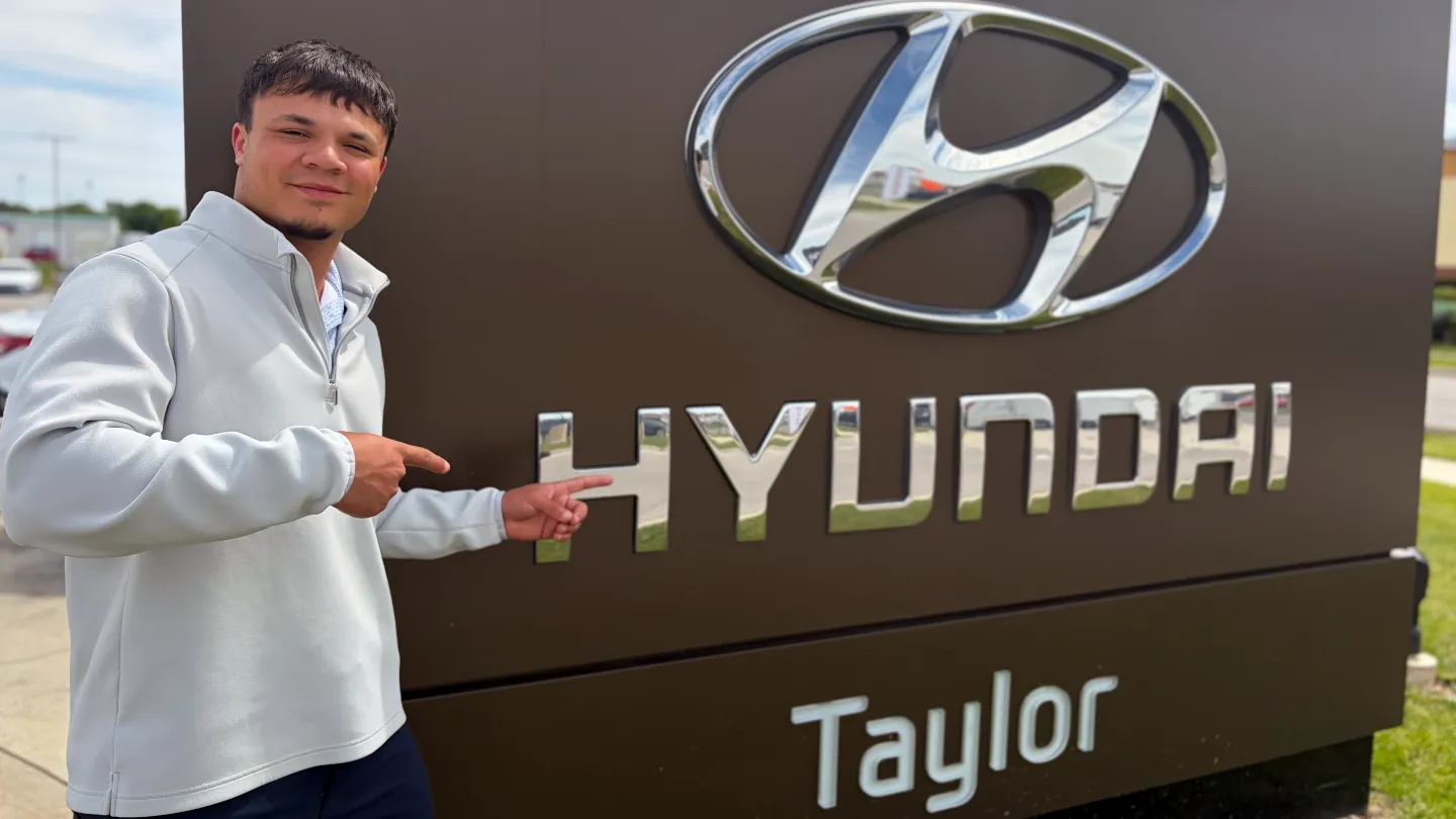Tucker Oliver with Taylor Hyundai sign