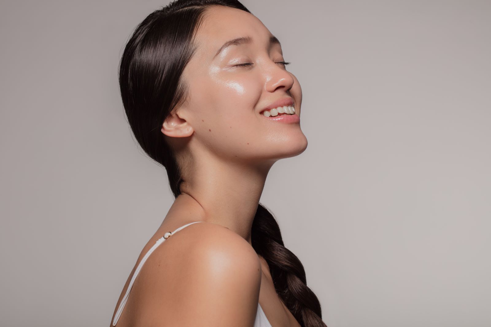 asian woman smiling with eyes closed