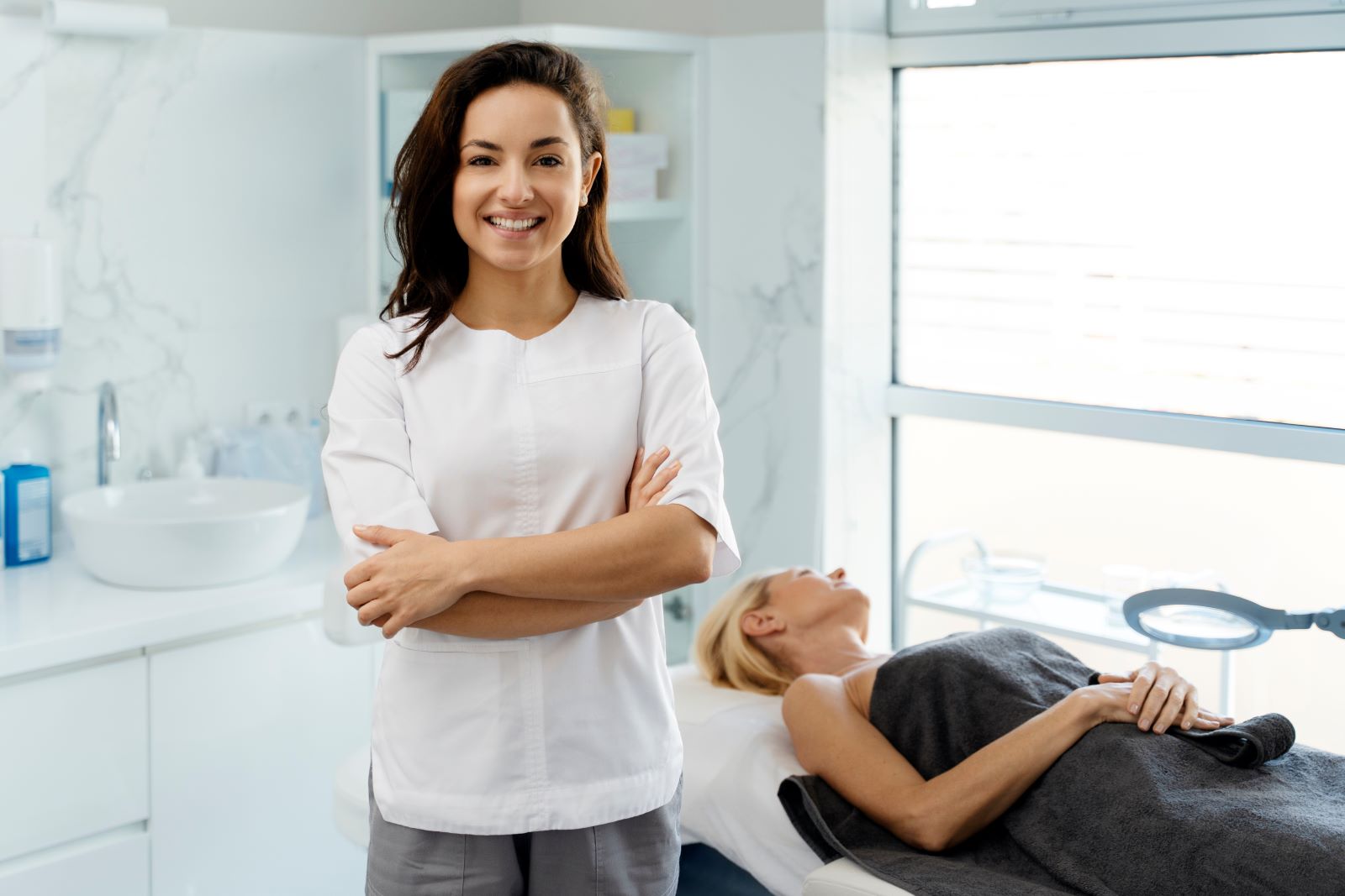 woman standing smiling with arms crossed