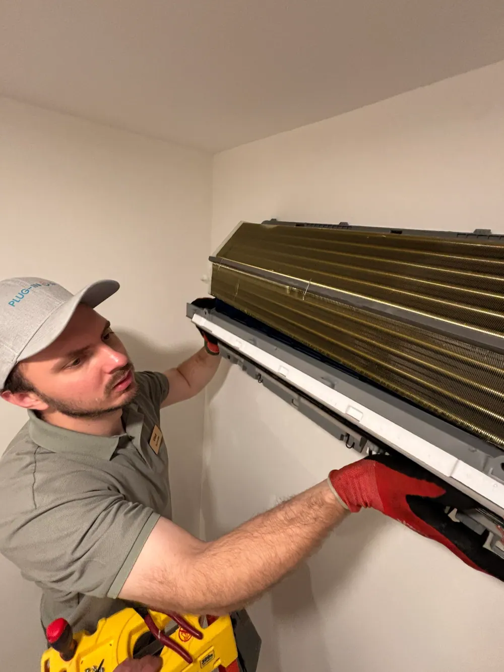 Vlad working on a wall-mounted mini-split indoor unit