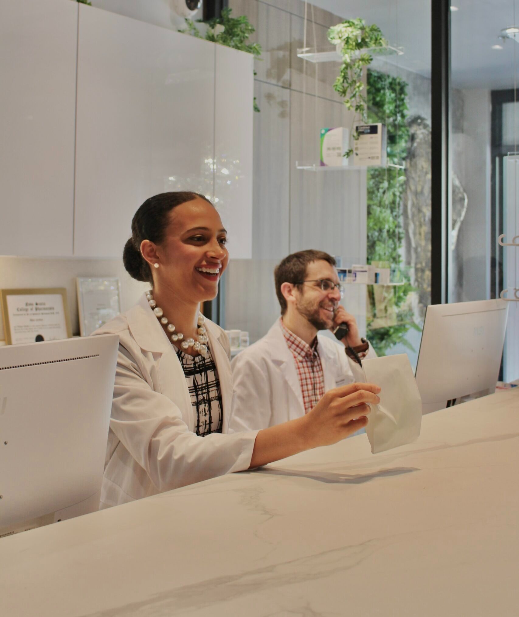 Pharmacists welcoming a patient at Cunard Pharmacy & Clinic on the Halifax waterfront