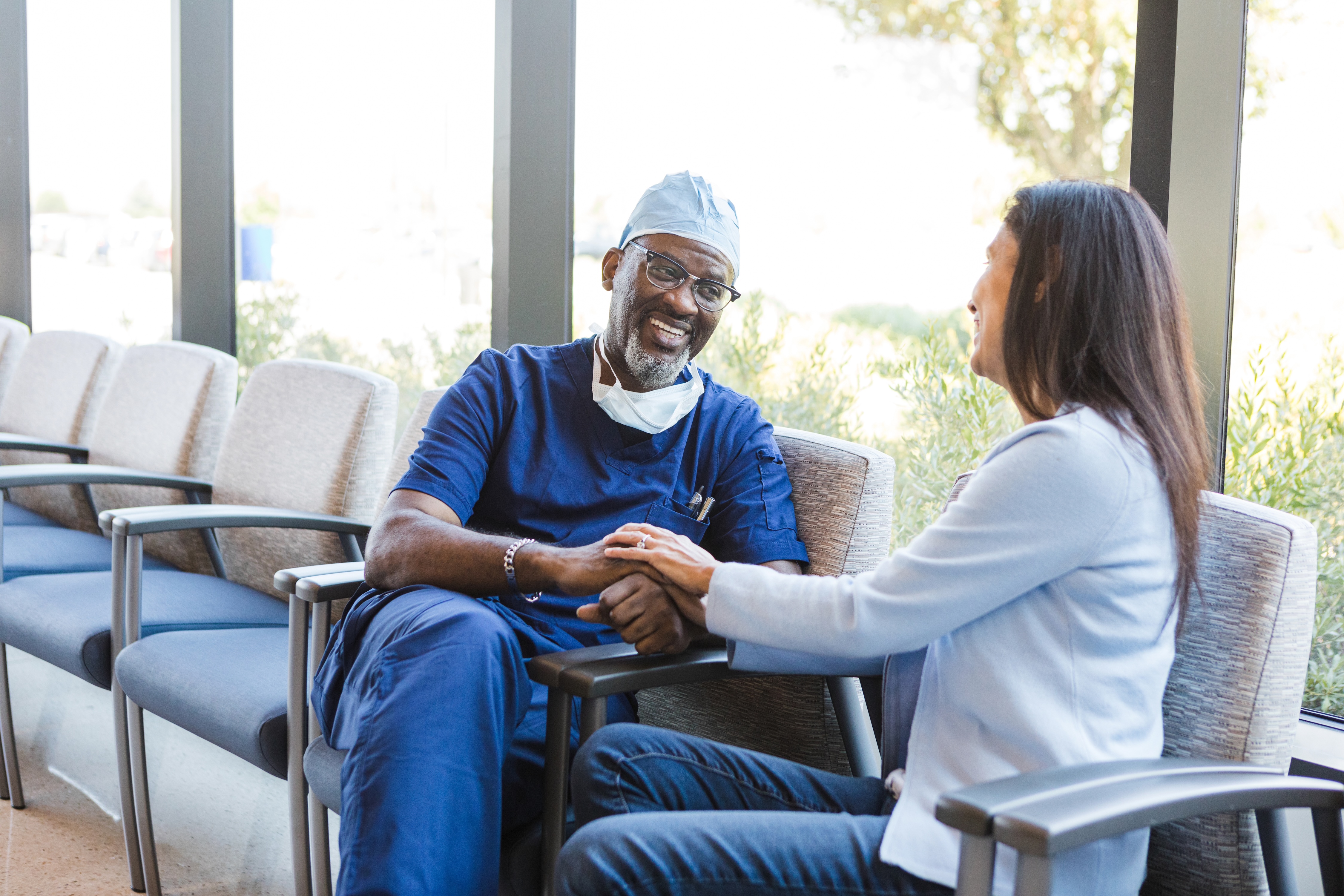 Surgeon consulting with a patient using iQueue for Surgical Clinics coordination software