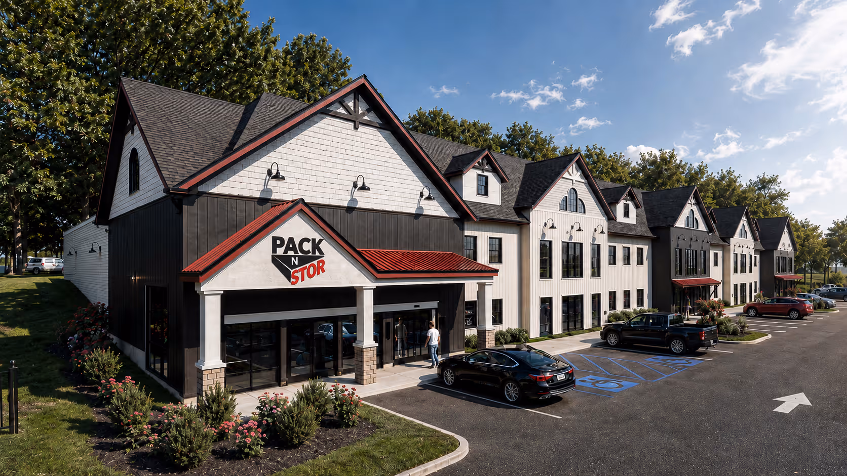 Modern Pack N Stor East Fishkill building with white and black exterior and parking lot with cars.