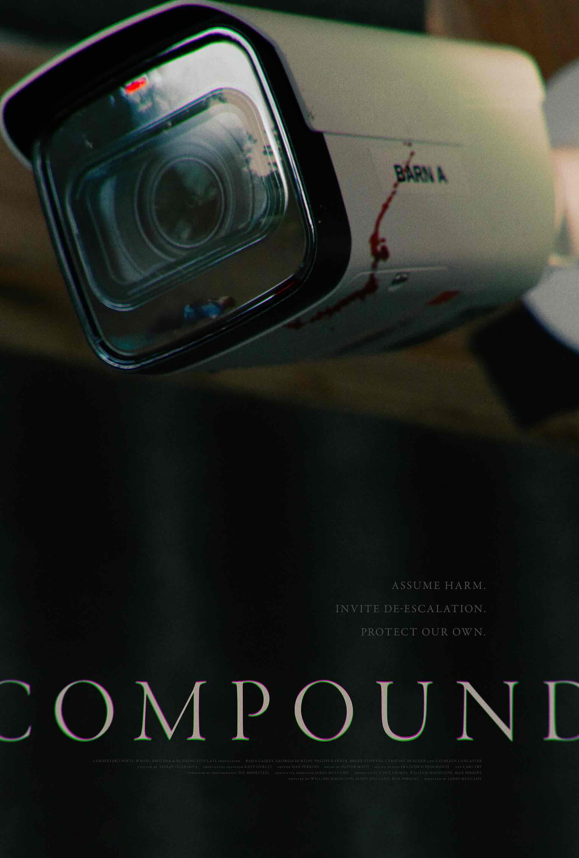 Close-up of a security camera with blood splatter and text reading 'COMPOUND'.