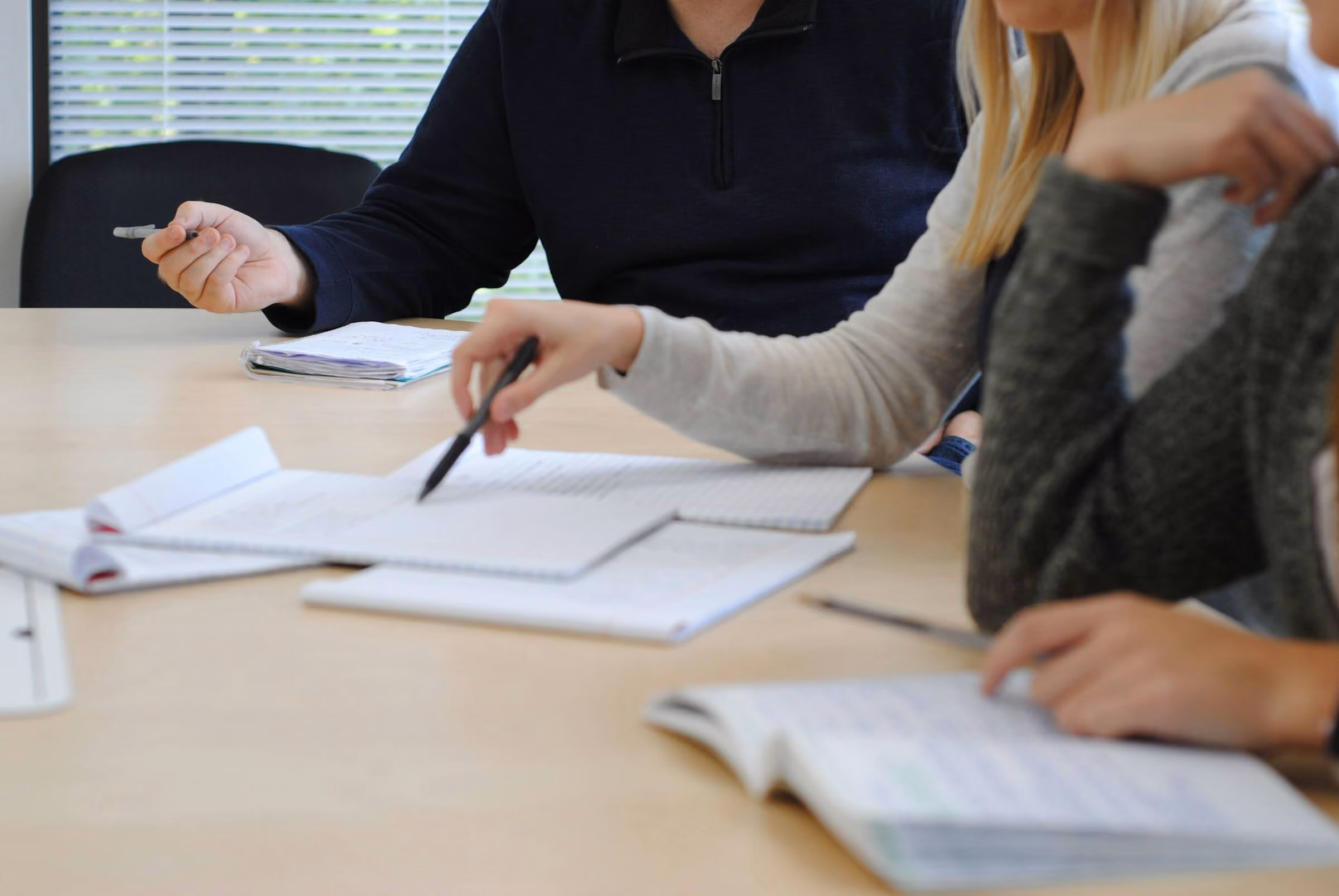 Team working through retirement plan documents at a conference table
