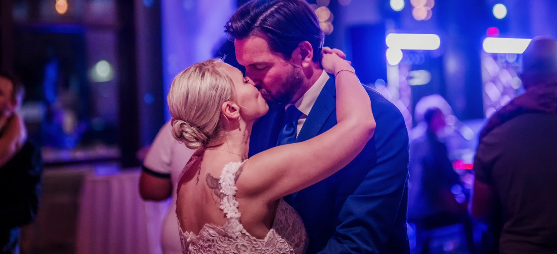Newlyweds sharing a kiss during a Piano Fondue wedding reception