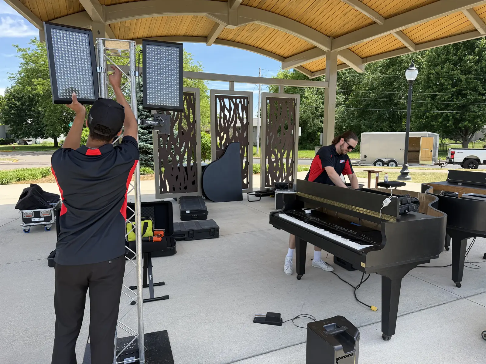 Piano Fondue team setting up pianos, sound, and lighting for a live show