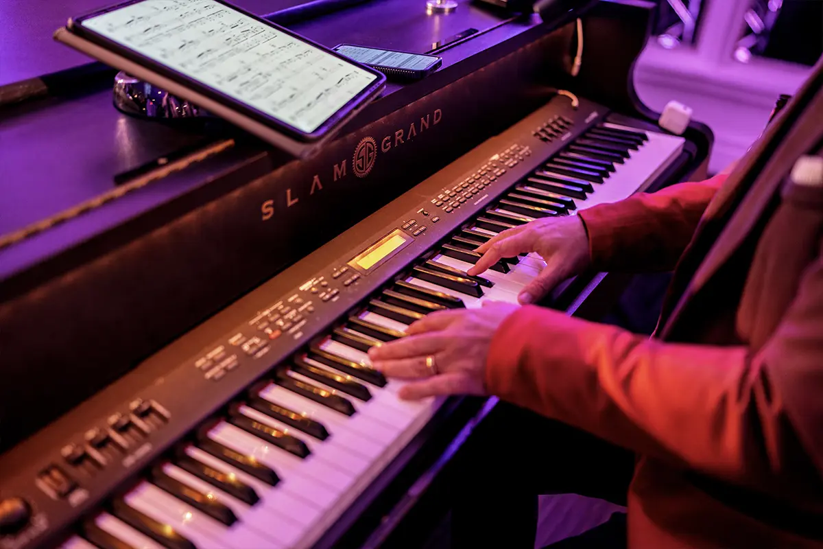 Pianist playing a grand piano during a Piano Fondue live show