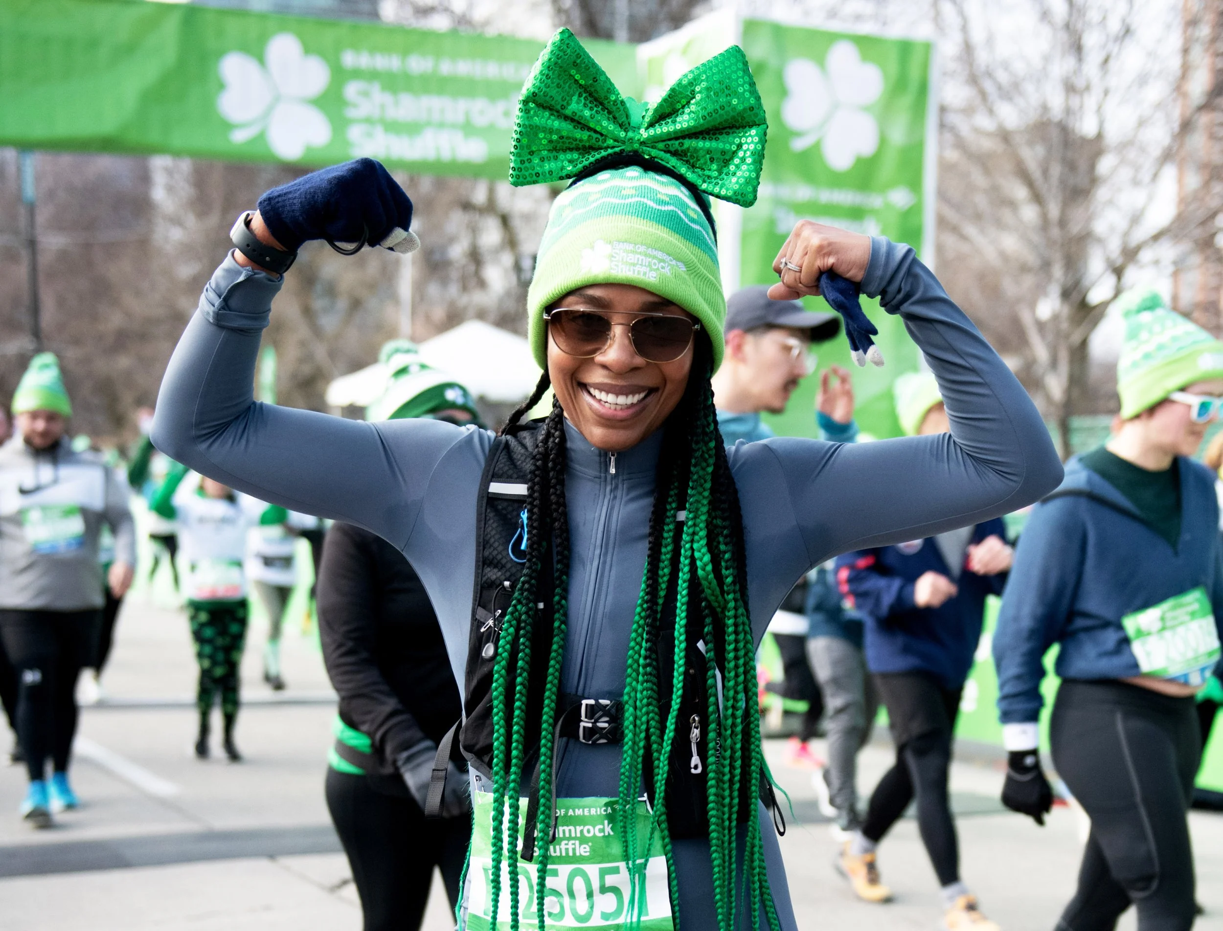 A woman flexing during The Bank of America Shamrock Shuffle
