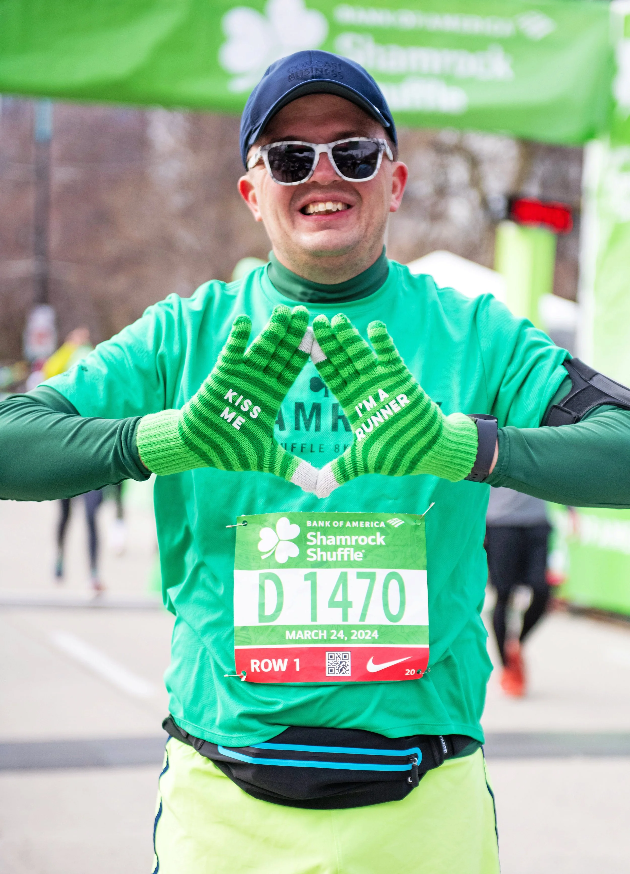 A runner smiling for a portrait at The Bank of America Shamrock Shuffle