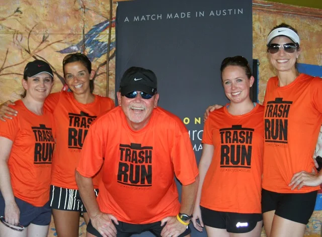 A group of runners taking a group photo during a Trash Run event