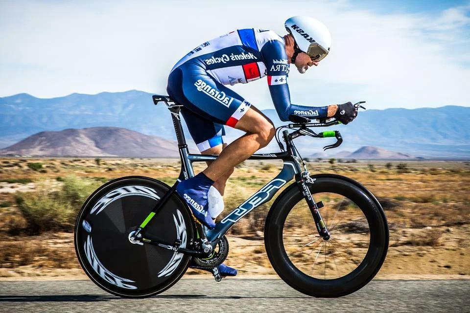 A cyclist riding on a remote road during a road race