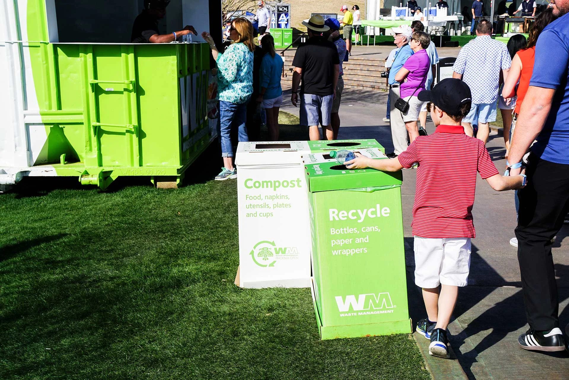 A young patron recycling a water bottle at the Waste Management Phoenix Open