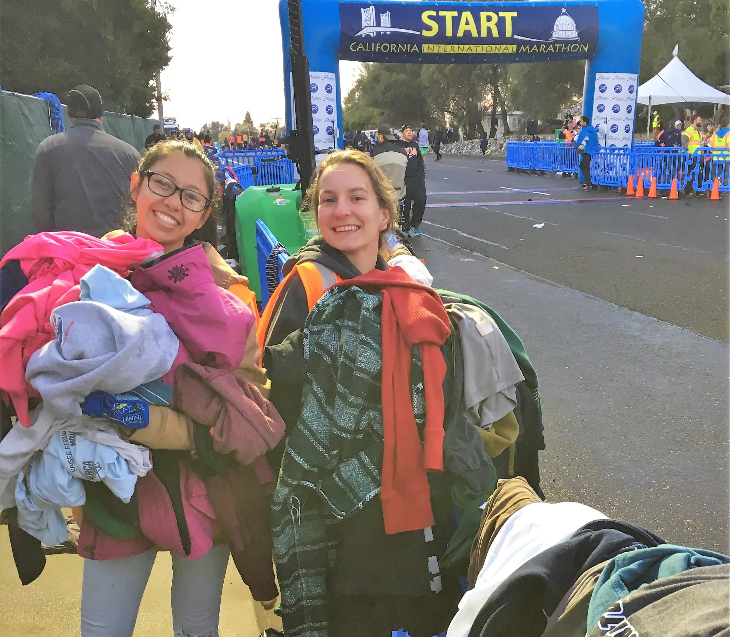 Volunteers holding donated clothes at the California International Marathon