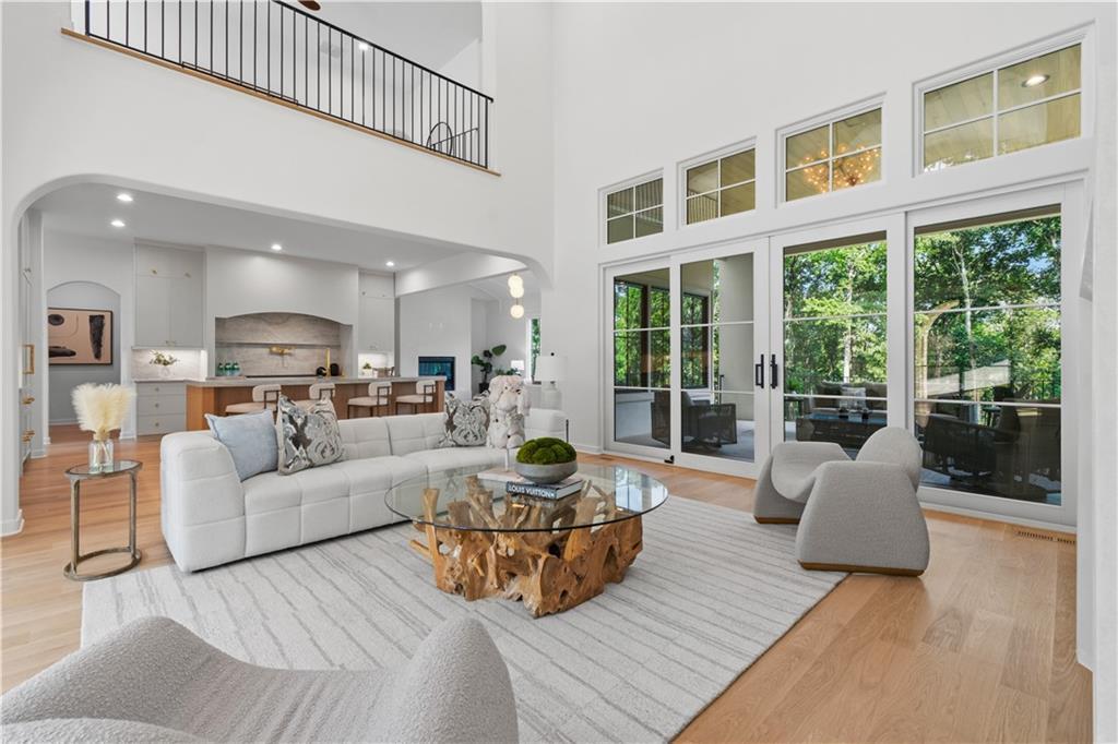 Open-concept great room leading to covered terrace and golf course views