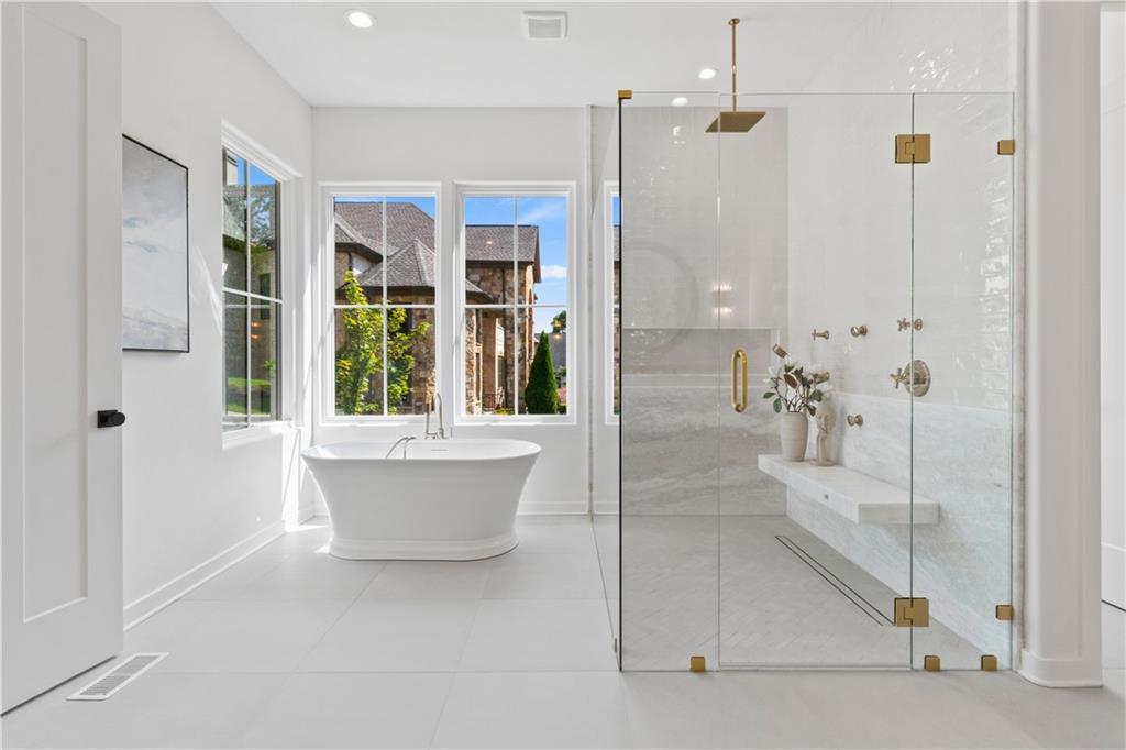 Primary bathroom with soaking tub and glass-enclosed shower