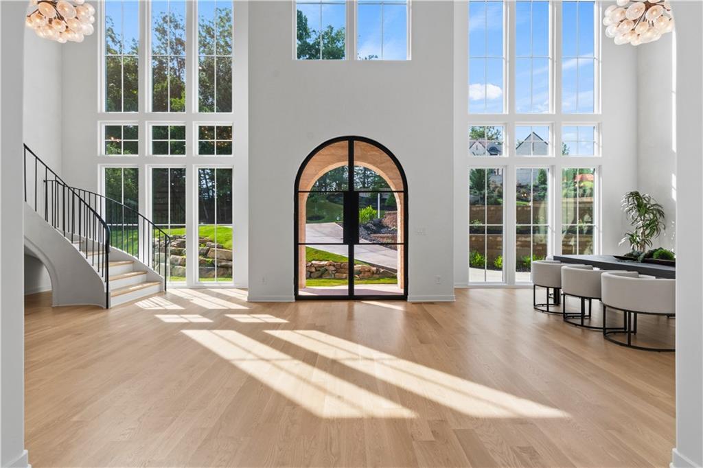 Two-story foyer with white oak flooring and floor-to-ceiling windows