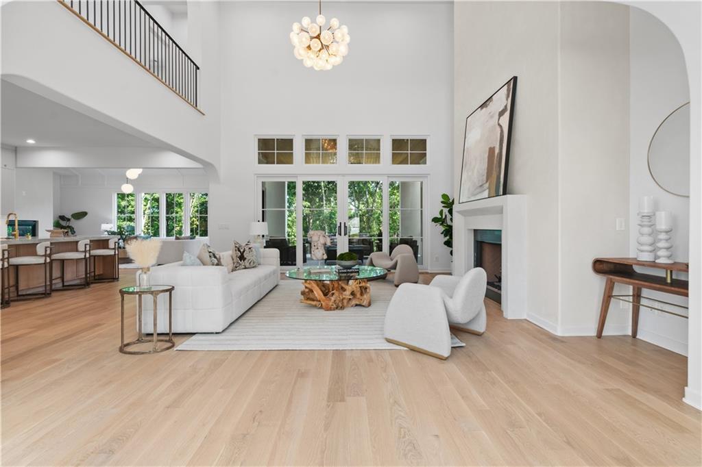 Great room with fireplace and two-story windows in custom Alpharetta home
