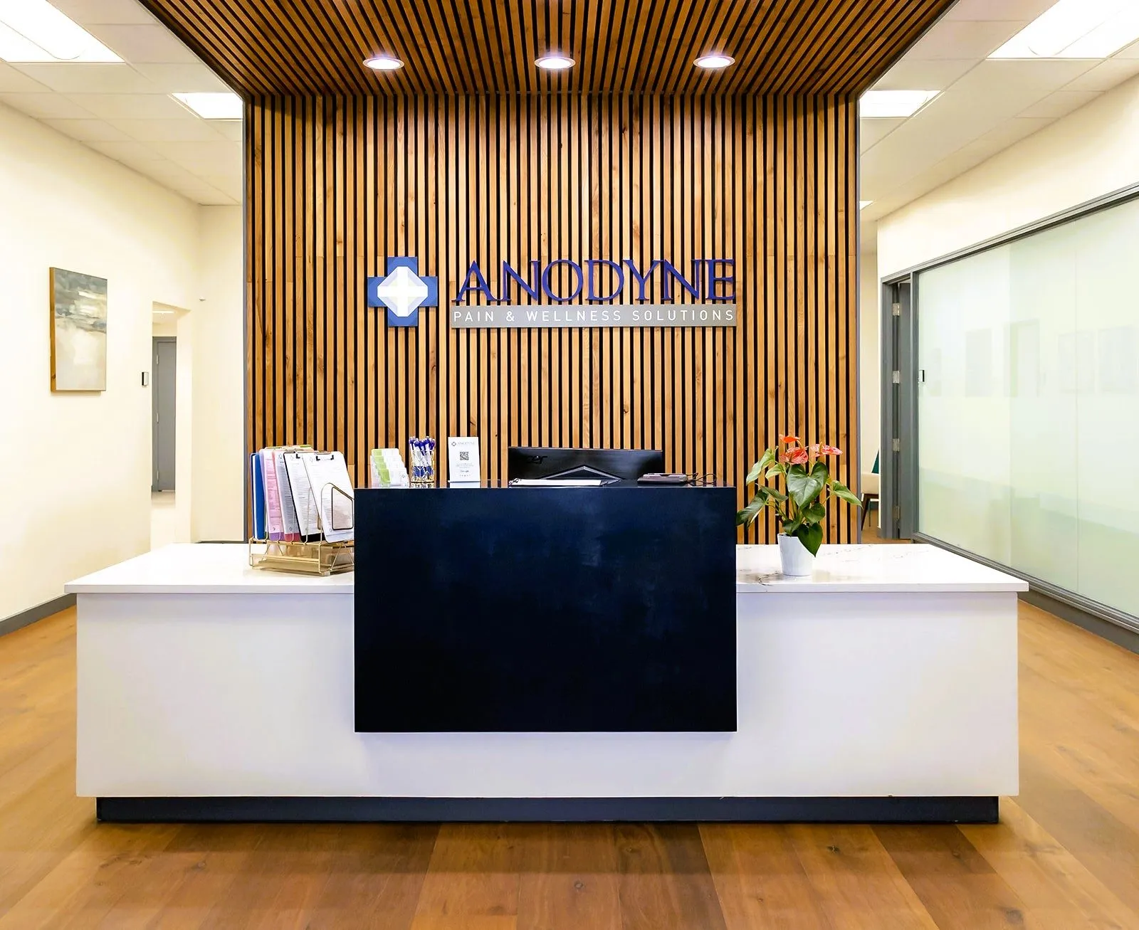 Anodyne Wellness Centers Marietta reception with custom wood feature wall