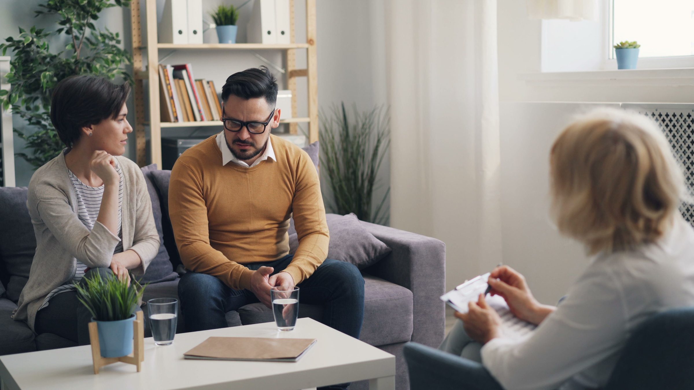 A couple meeting with a mediator in a calm, seated setting