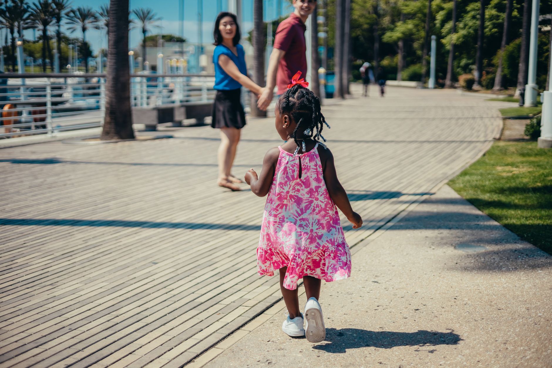 A joyful family enjoying a walk outdoors on a sunny day, capturing family bonding.