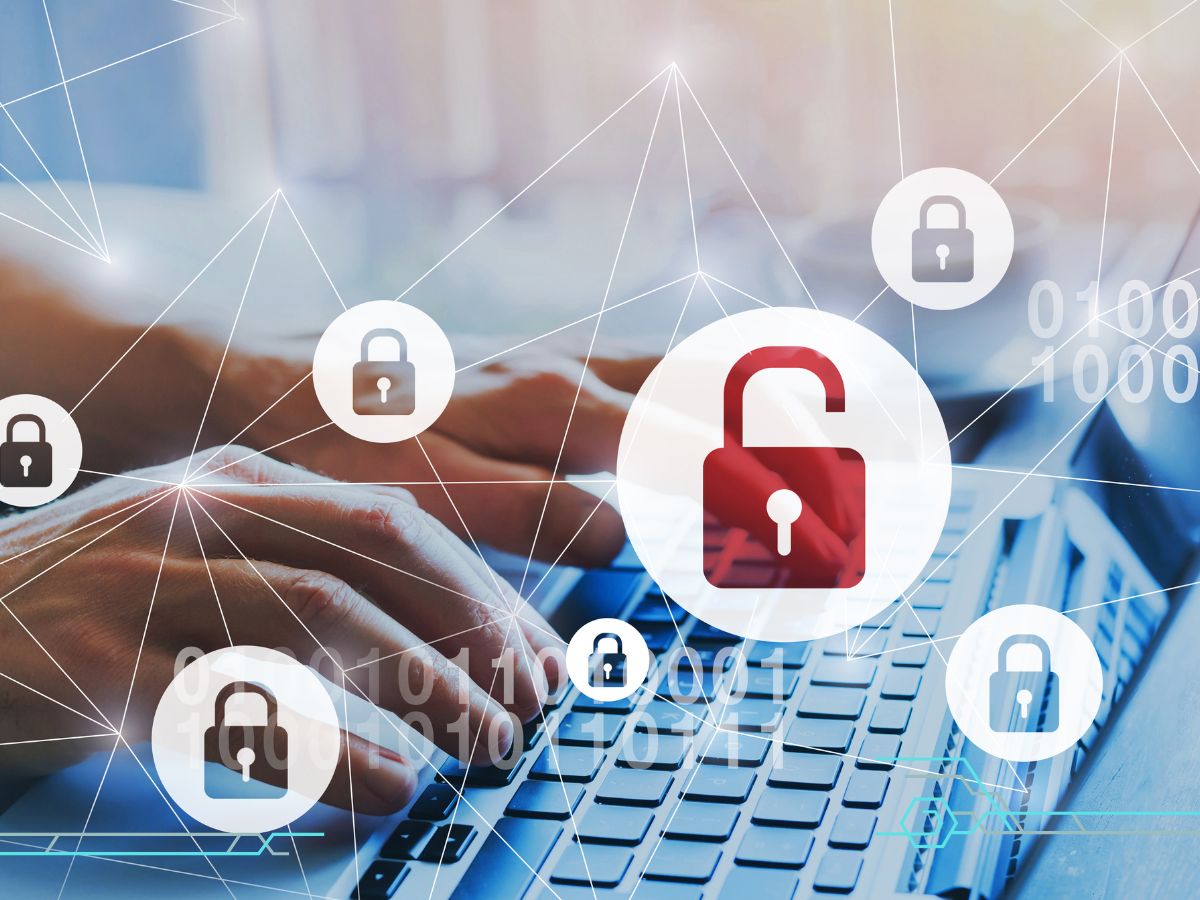 Two hands clicking the laptop keyboard and a security lock icon