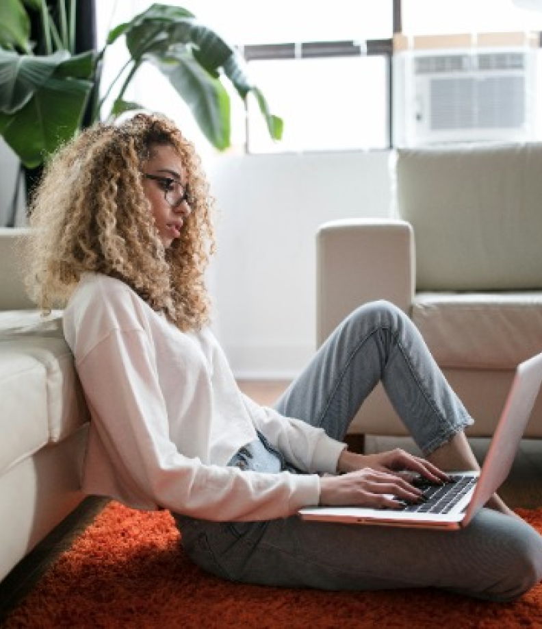 A picture of a woman in her laptop.