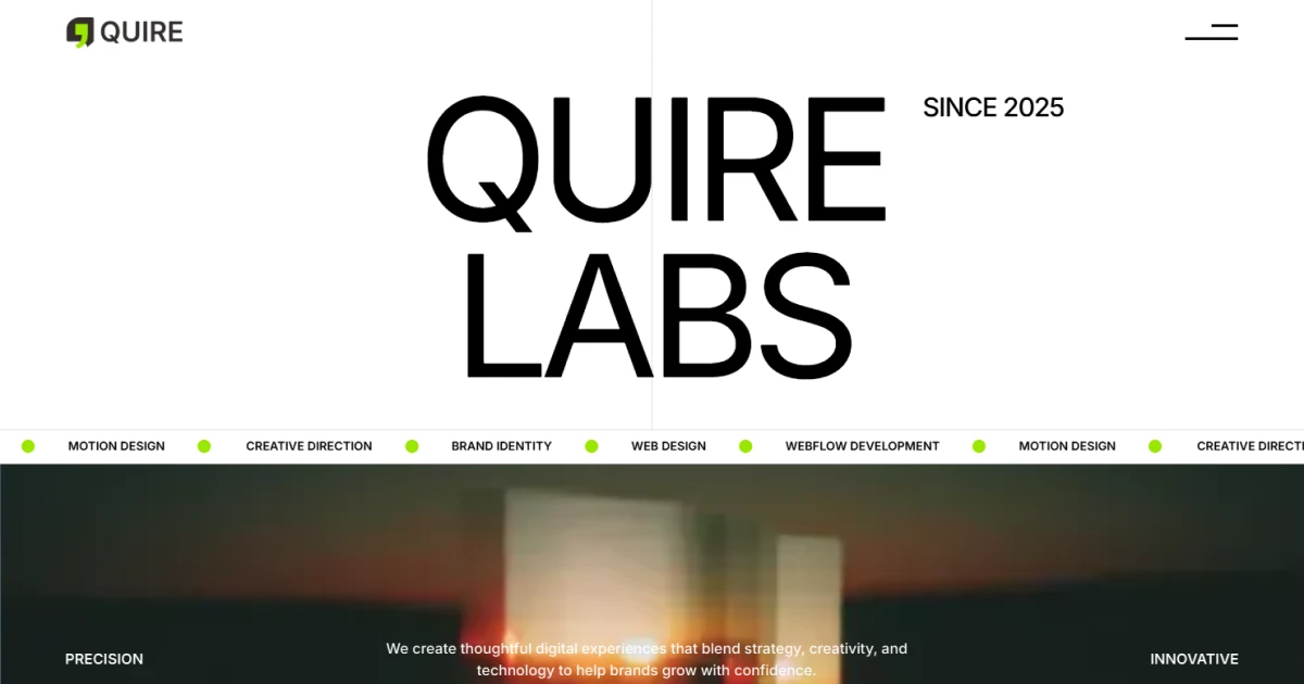 Webpage header for QUIRE LABS with menu, tagline about digital strategy and creativity, and blurred background.