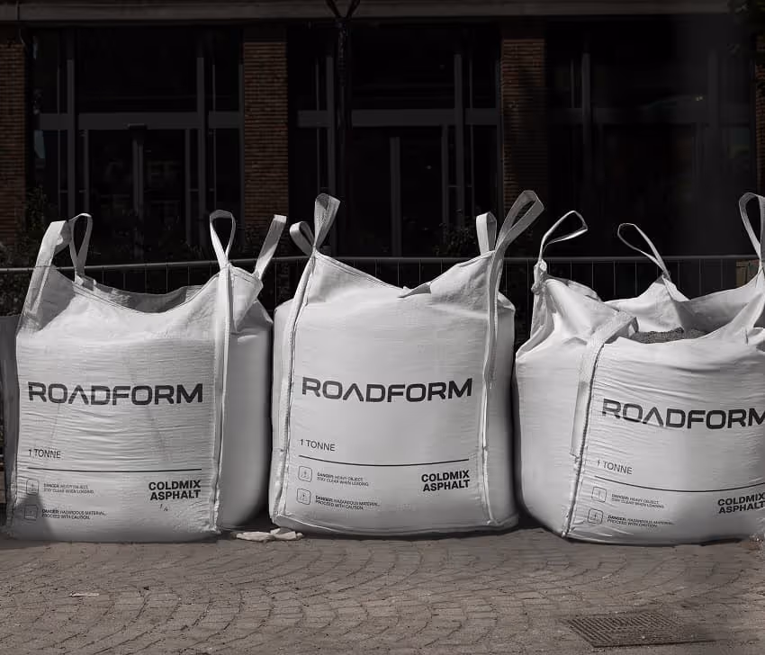 Roadform Coldmix solution — freshly patched asphalt road surface using cold mix technology.